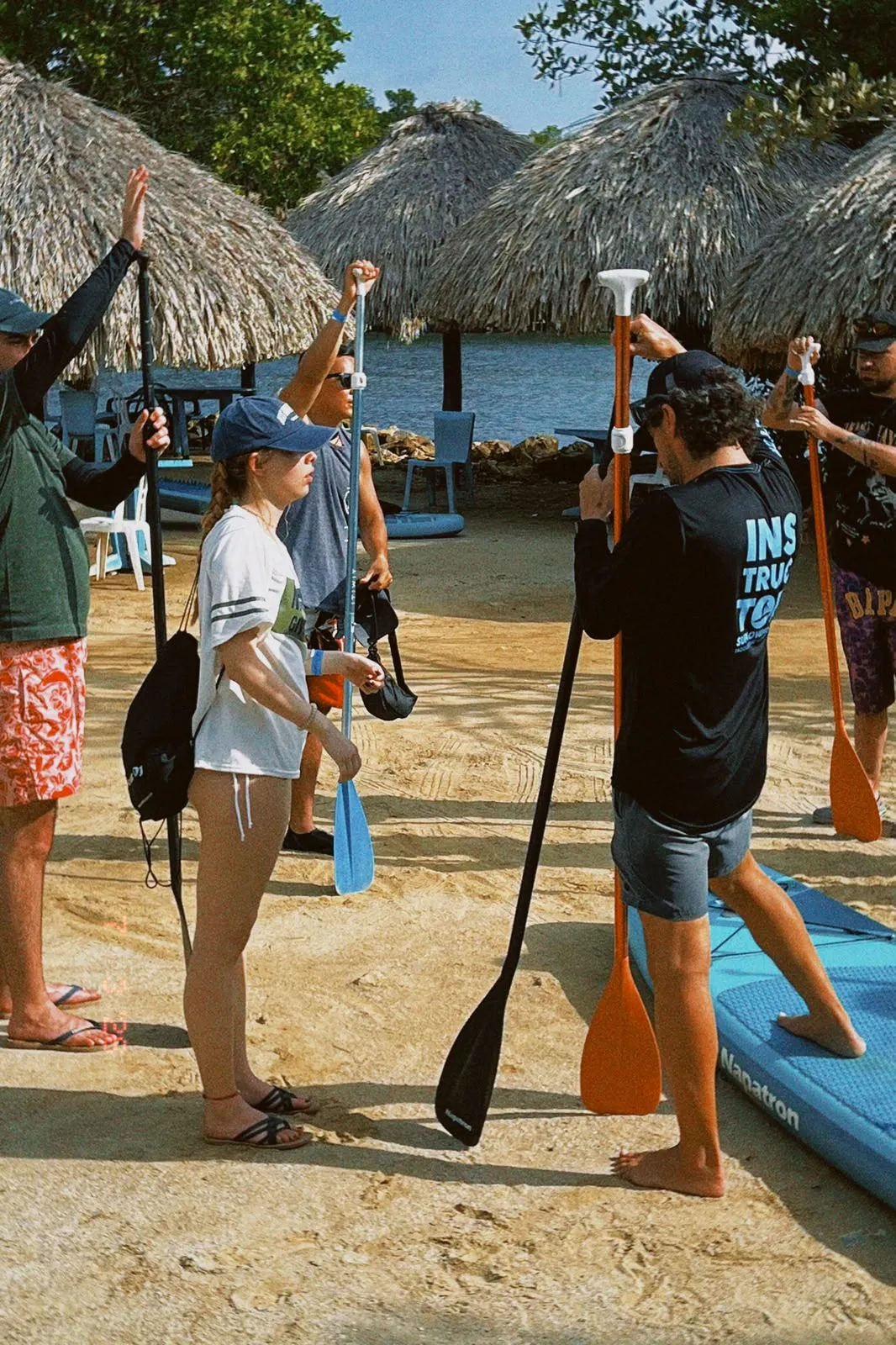 SUP lovers instructor explaining how to hold the paddle before the tour